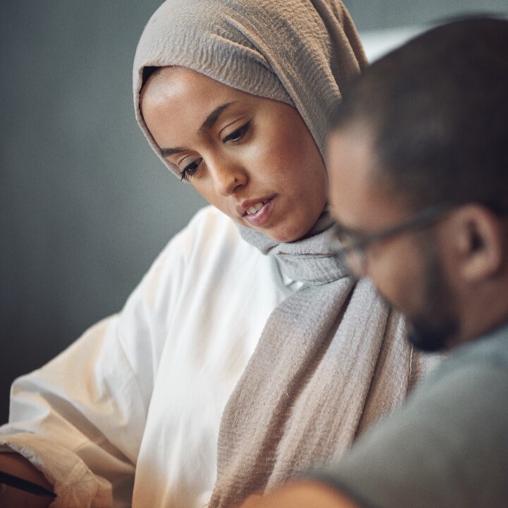 Female and male employee are discussing work.