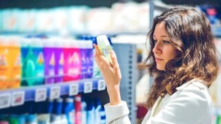 Woman holding fmcg product in supermarket