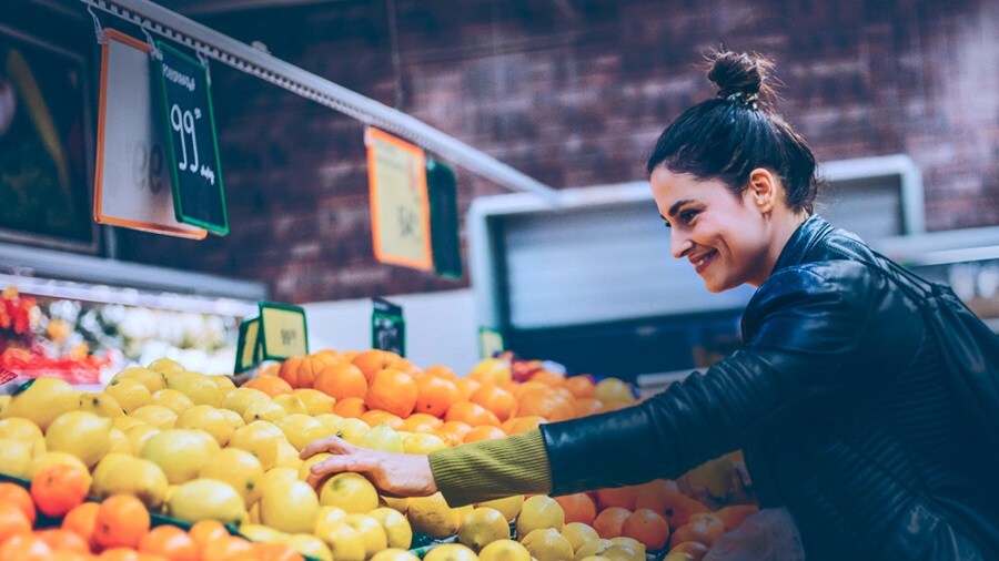 Female picking fruits in a marts