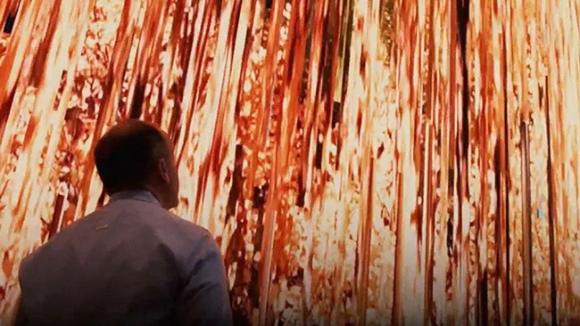 Person looking at a large, glowing art display