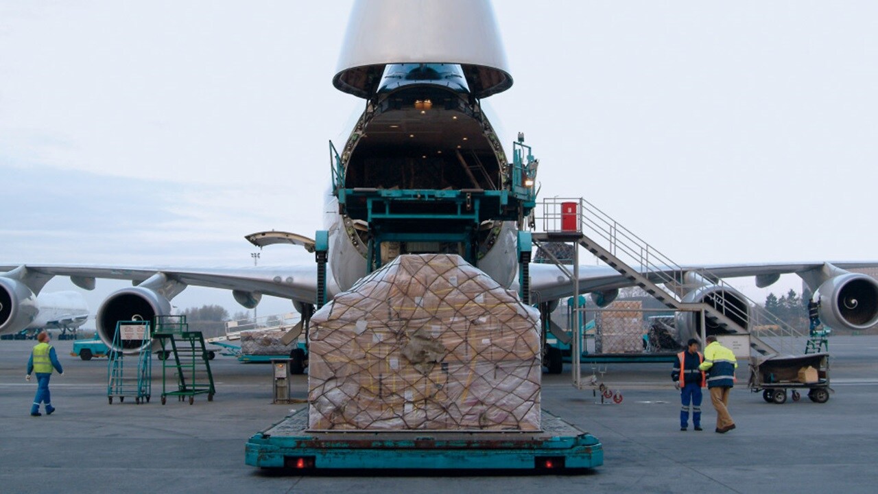 An airplane with a large cargo container positioned on top, showcasing its capacity for freight transport.