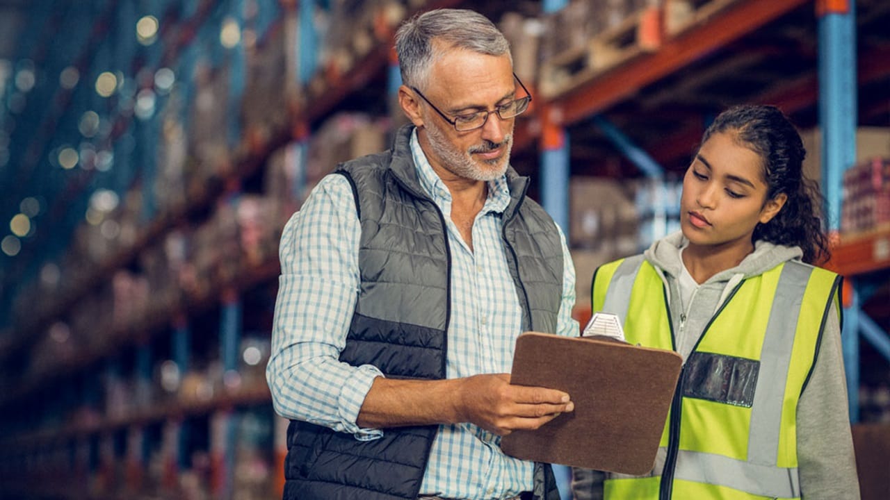 两位员工正在讨论盘点仓库中的拼箱货。